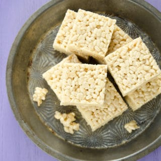 overhead photo of rice krispie treats cut and assembled on pewter tray