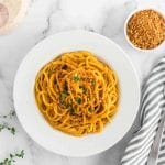 bowl with sweet potato pasta sauce in spaghetti noodles