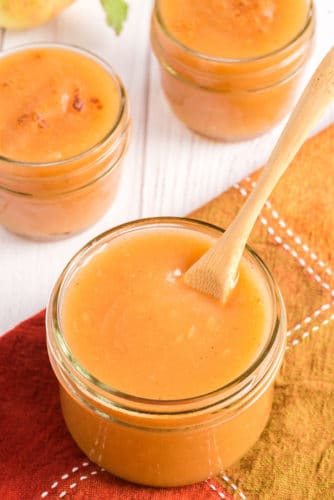 instant pot applesauce in glass jar with spoon