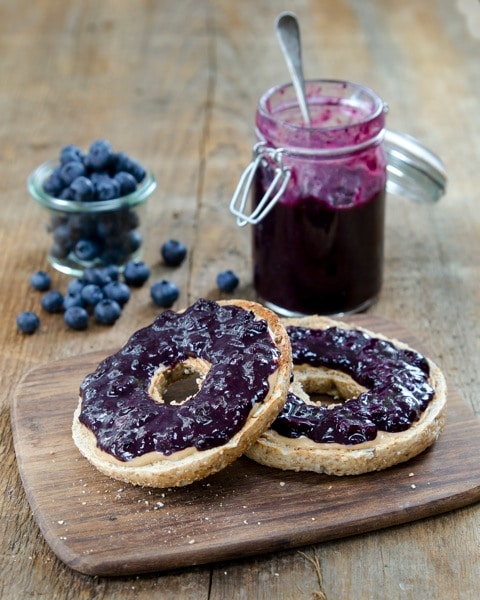 Sugar-Free Blueberry Jam on sliced bagel, and jar of berry jam in background