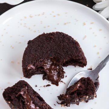 vegan chocolate lava cakes serving with centre of melted chocolate shown